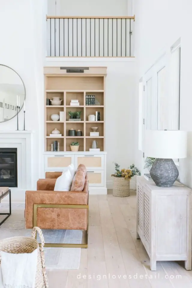 slow deco salon familial minimaliste exemple pièce lumineuse blanche canapé cuir bibliothèque bois
