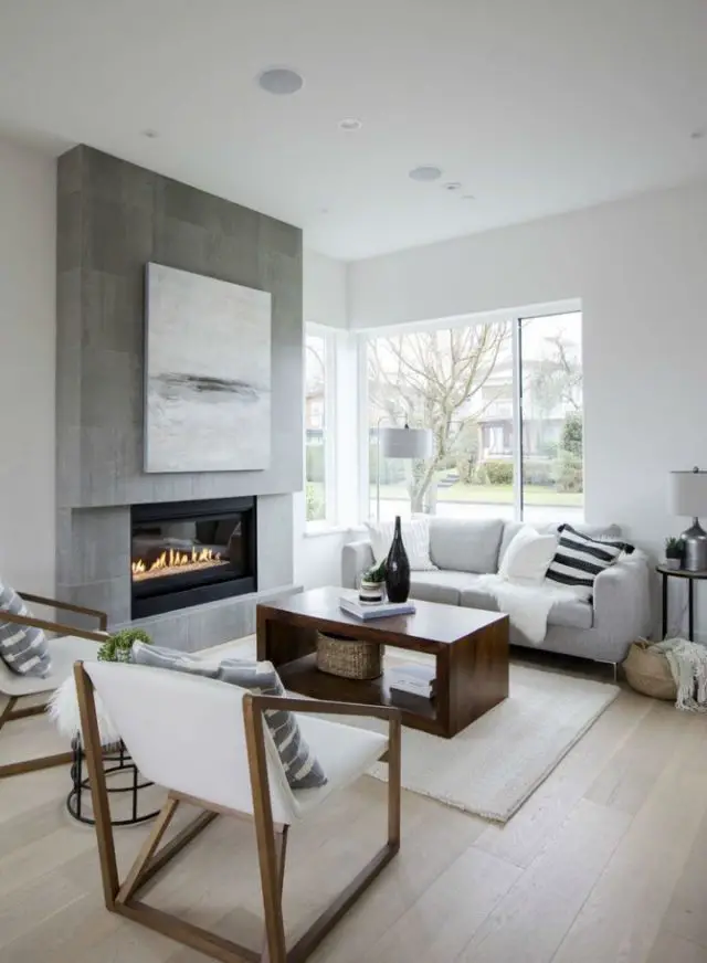 slow deco salon familial minimaliste exemple grande cheminée foyer ouvert béton ciré