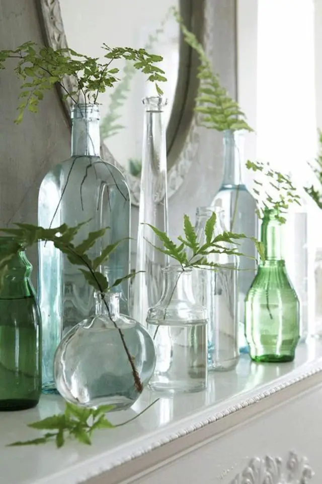 decorer avec objet en verre exemple contenant vase transparent et coloré dessus meuble