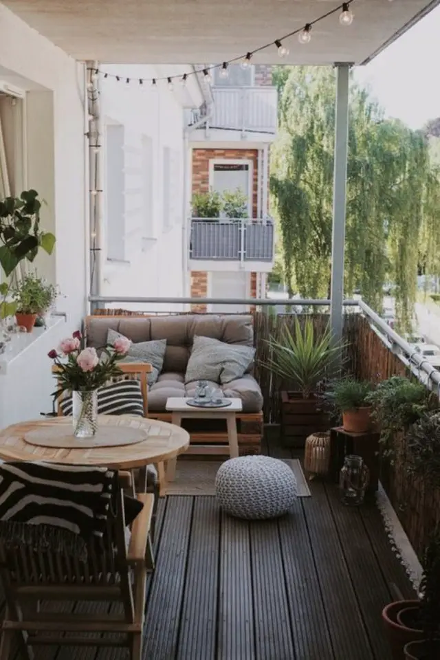 happy small living decoration petit logement balcon banquette palette table ronde 2 personnes cosy confort plantes vertes