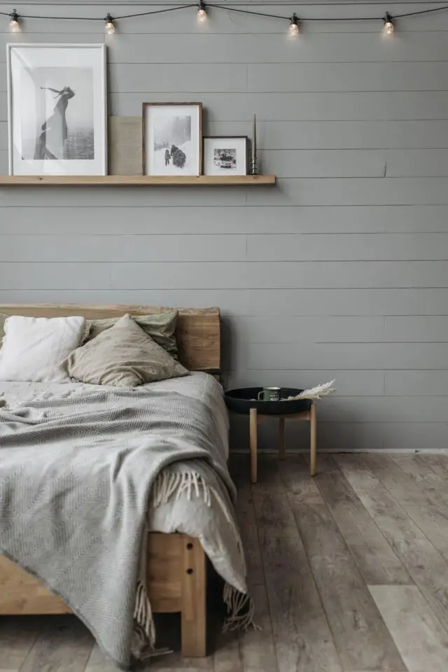 travaux renovation bricolage chambre parentale revêtement lambris mural peint en gris ambiance douce et reposante lit en bois étagère cadre