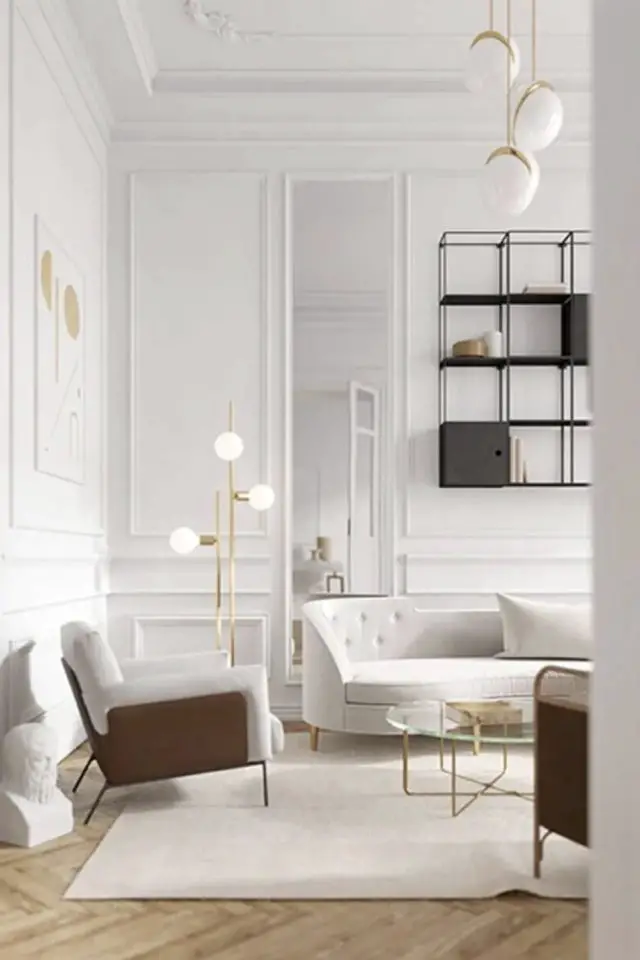caracteristique decor minimaliste blanc couleur lumineuse moulure classique canapé et fauteuil clair bibliothèque murale foncée épurée