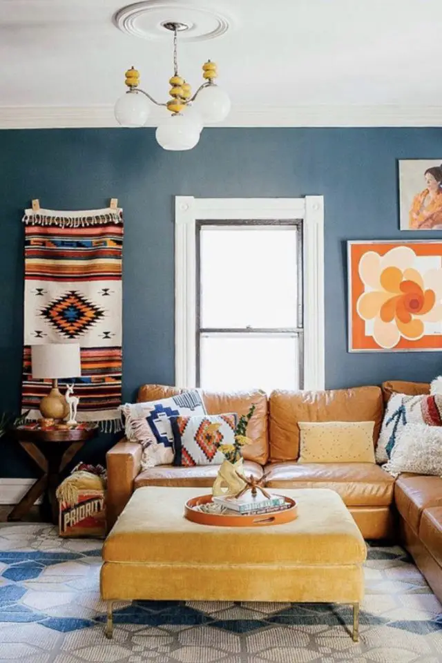 visite deco maison decor eclectique salon familial canapé en cuir d'angle vintage coussin motif ethnique peinture mur bleu tendance