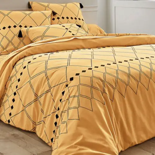 linge de maison couleur jaune violet blancheporte Linge de lit Massai coton à motifs graphiques et finitions pompons