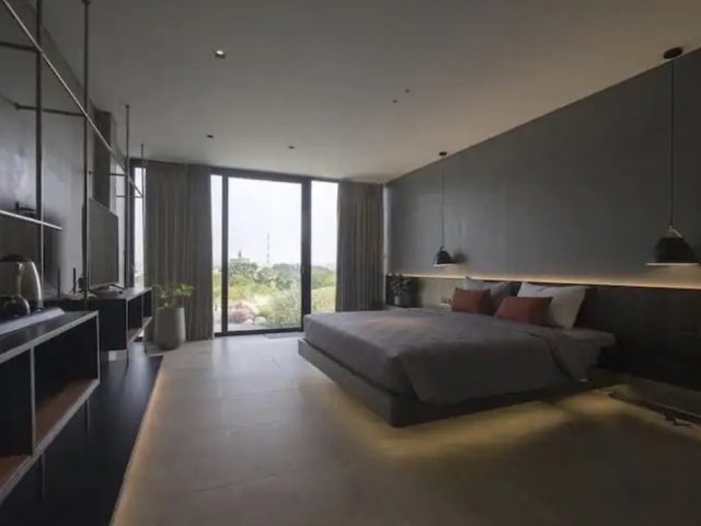 voyager vietnam luxe villa design minimalisme chambre à coucher adulte décor sobre et épuré palette de couleur gris neutre sombre