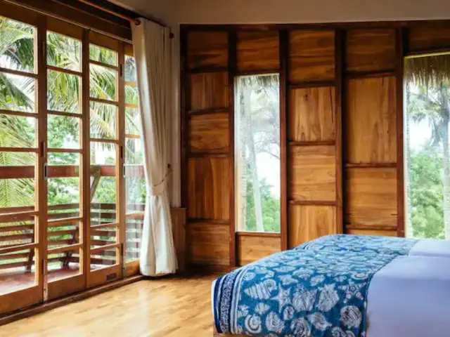 bungalow haut de gamme voyage indonesie baie vitrée cloison en bois design vacances chambre à coucher inspiration