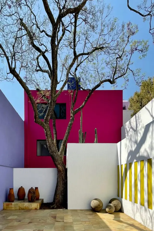 caracteristique definition architecture minimaliste extérieur façade cube coloré rose mauve jaune découpage paysage