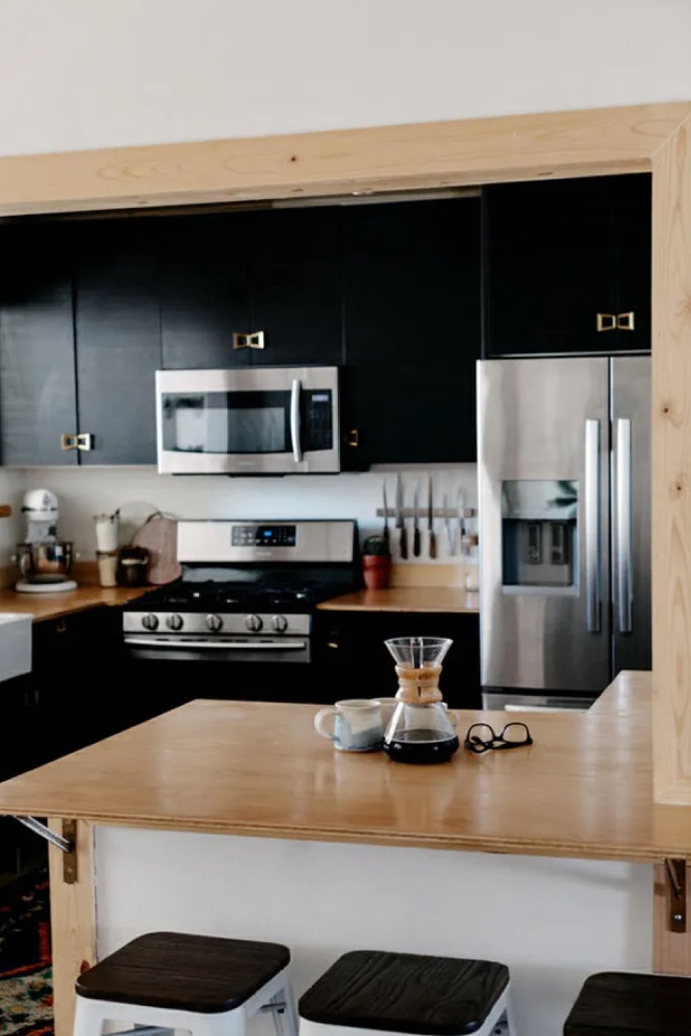 visite maison deco boheme retro chic cuisine moderne noir contraste avec bois clair et peinture blanche îlot central