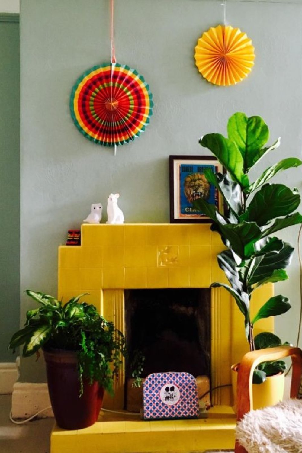 creer touche de couleur deco exemple pièce à vivre peinture mur vert clair cheminée faïence jaune plante verte décor murale papier