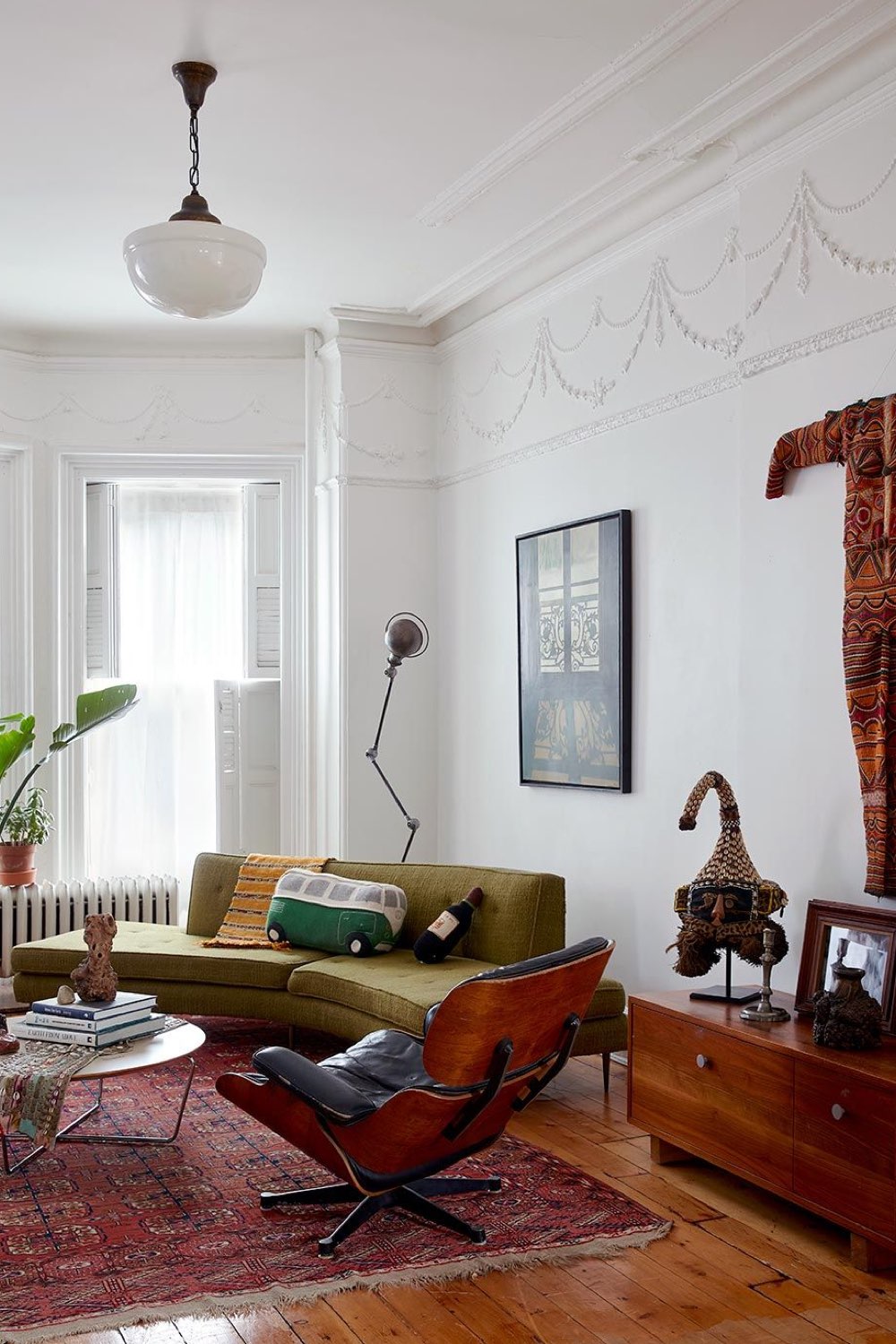 maison ancienne charme eclectique décoration de salon canapé arrondi vert fauteuil Eames mur blanc