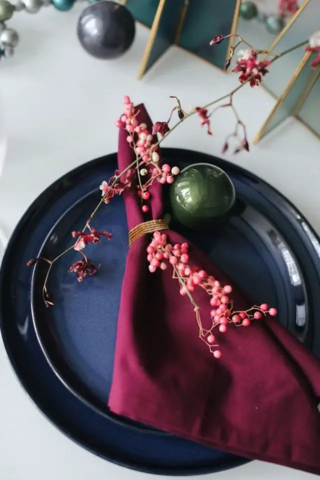 table de noel chic exemples nappe blanche assiettes bleu marine serviette prune élégant