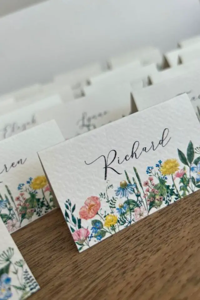décoration de mariage au printemps marque-place plié en carton blanc dessin fleurs jolie typo élégante