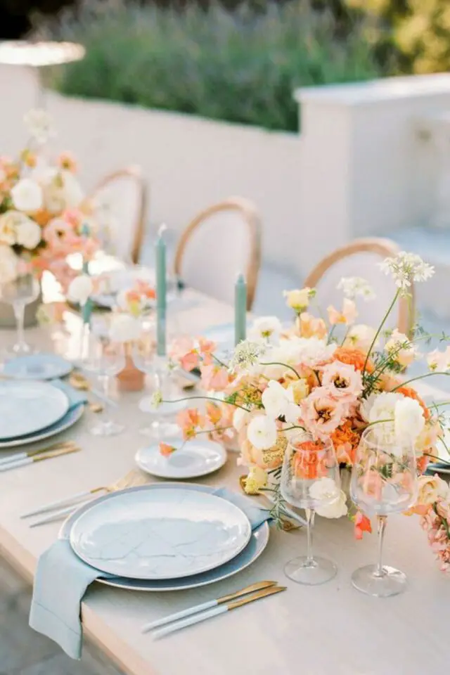 decoration de table couleur pastel mariage chic et élégant assiettes unies bleue bouquet rose et pêche bougie