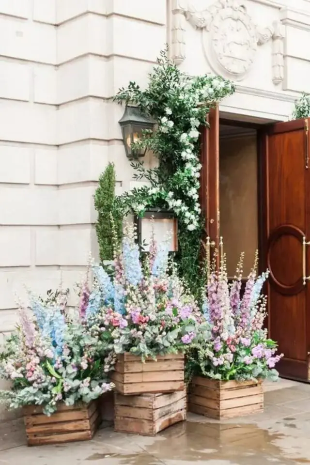 décoration de mariage au printemps entrée salle de réception cagettes en bois bouquets de fleurs parme bleu blanc