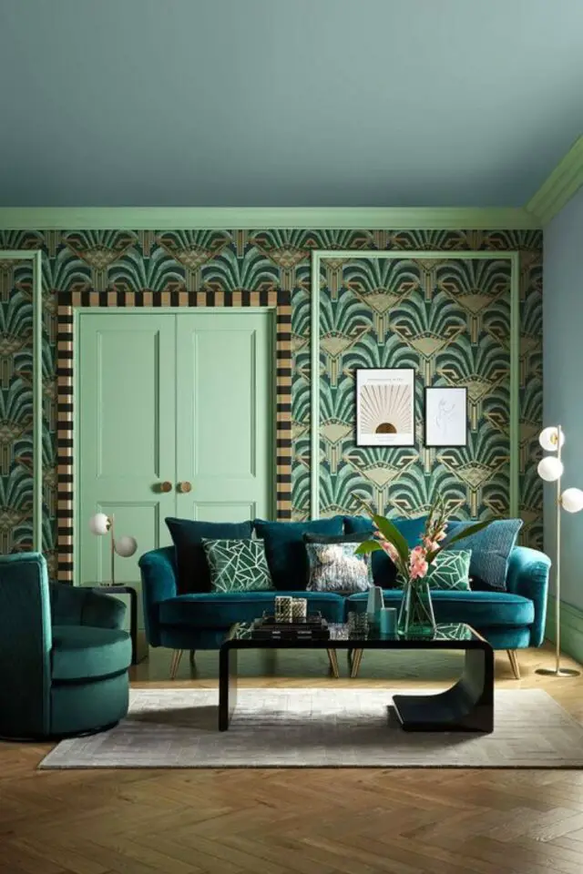 creer interieur art deco salon séjour nuance bleu vert papier peint motif canapé bleu paon en velours table basse noire lampadaire métal doré 