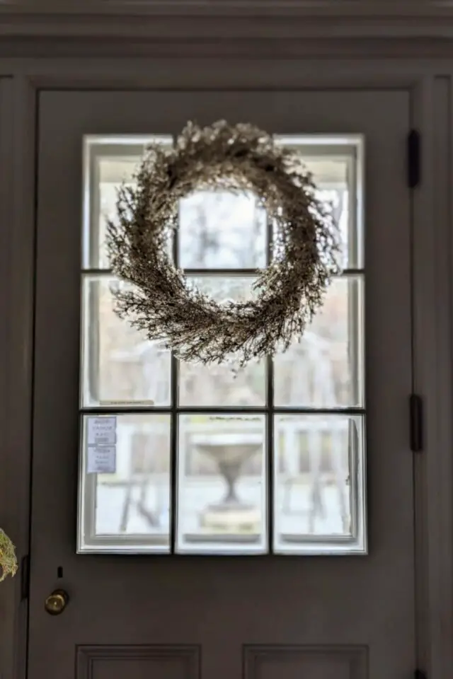 décoration intérieur film de noël porte vitrée avec croisillons et couronne accrochée 