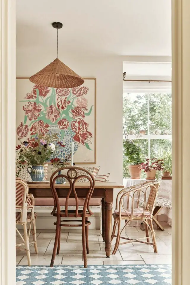 salle à manger décoration murale tableau fond clair comme le mur dessin floral espace élégant et printanier chaises dépareillée table rectangulaire en bois 