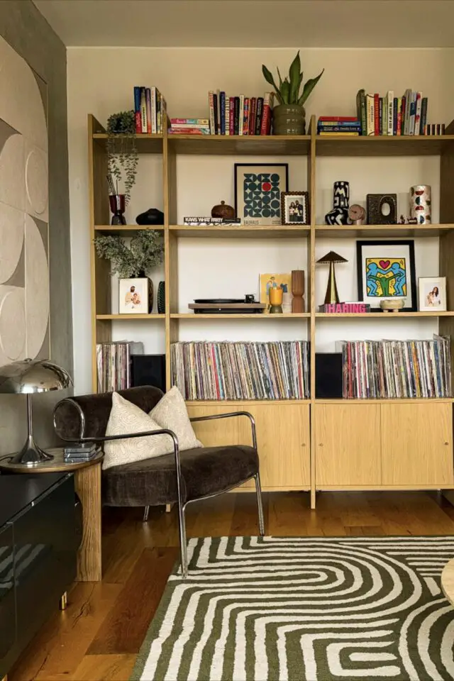 meuble bibliothèque rangement collection vinyle salon mobilier en bois chic et élégant fauteuil design vintage en velours tapis motif cert et blanc 