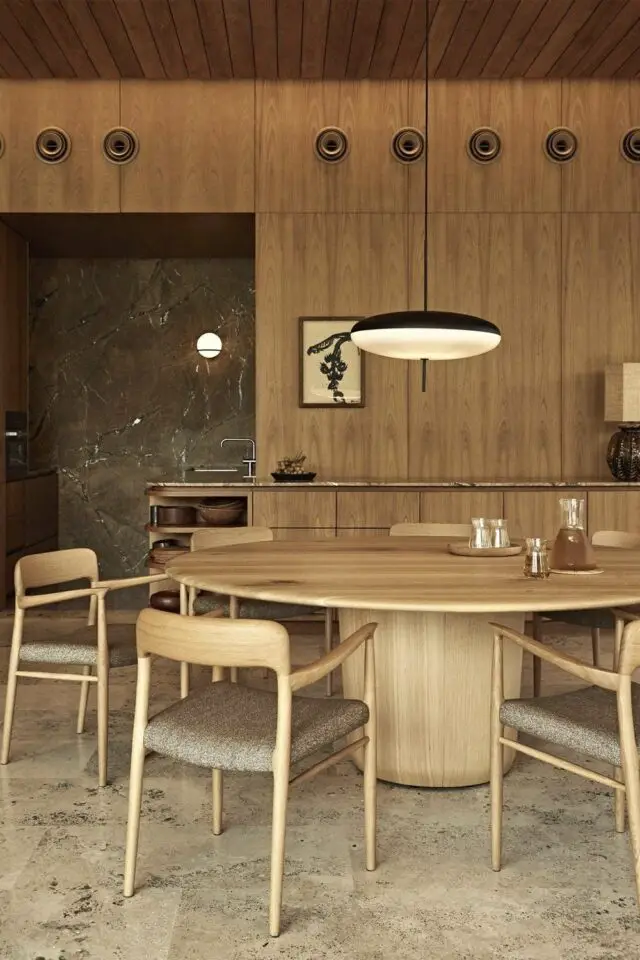 grande table ronde en bois piètement central rond ambiance chaleureuse salle à manger cuisine meuble et mur en bois suspension design 